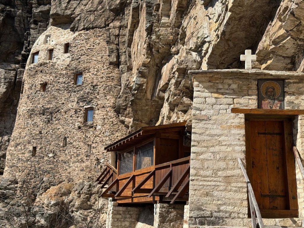 Fasada Savine isposnice i drveni balkon na litici iznad reke Studenice
